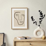 Stylish interior of living room with mock up poster frame, wooden commode, book, eucalyptus leaf in ceramic vase and elegant personal accessories. Minimalist concept of home decor. Template.
