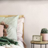 Stylish bedroom interior with design coffee table, plant, gold clock and elegant personal accessories. Beautiful bed sheets, blanket and pillows. Template. Modern home staging. Wall panelling. Details